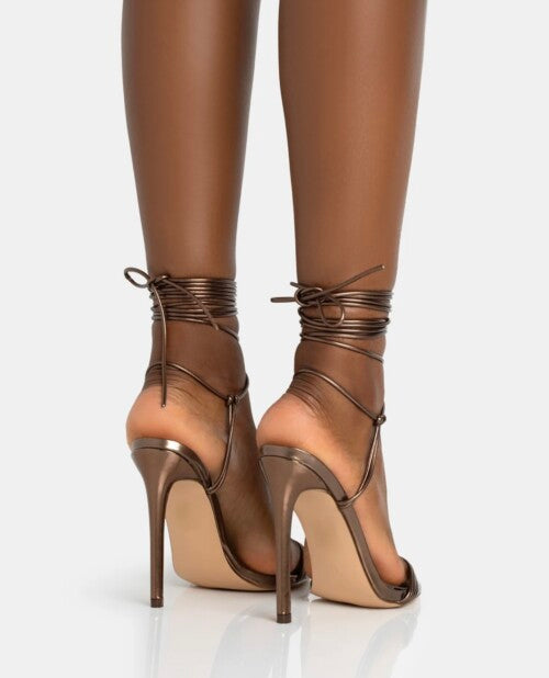 PUBLIC DESIRE TUBE STRAP HEELED SANDAL IN BRONZE